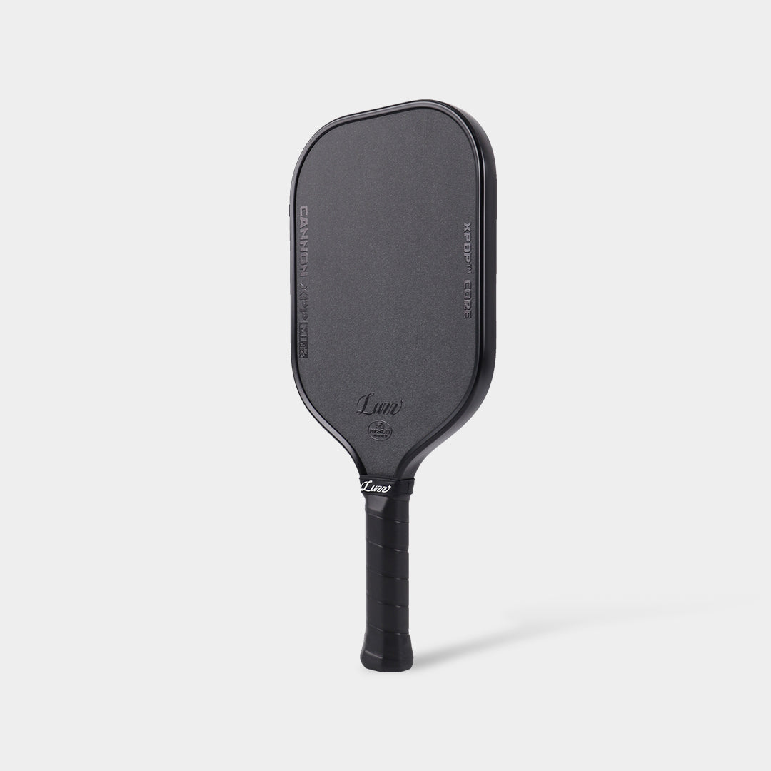 Low-angle view of the LUZZ Cannon XPP M1 paddle with black wrapped grip