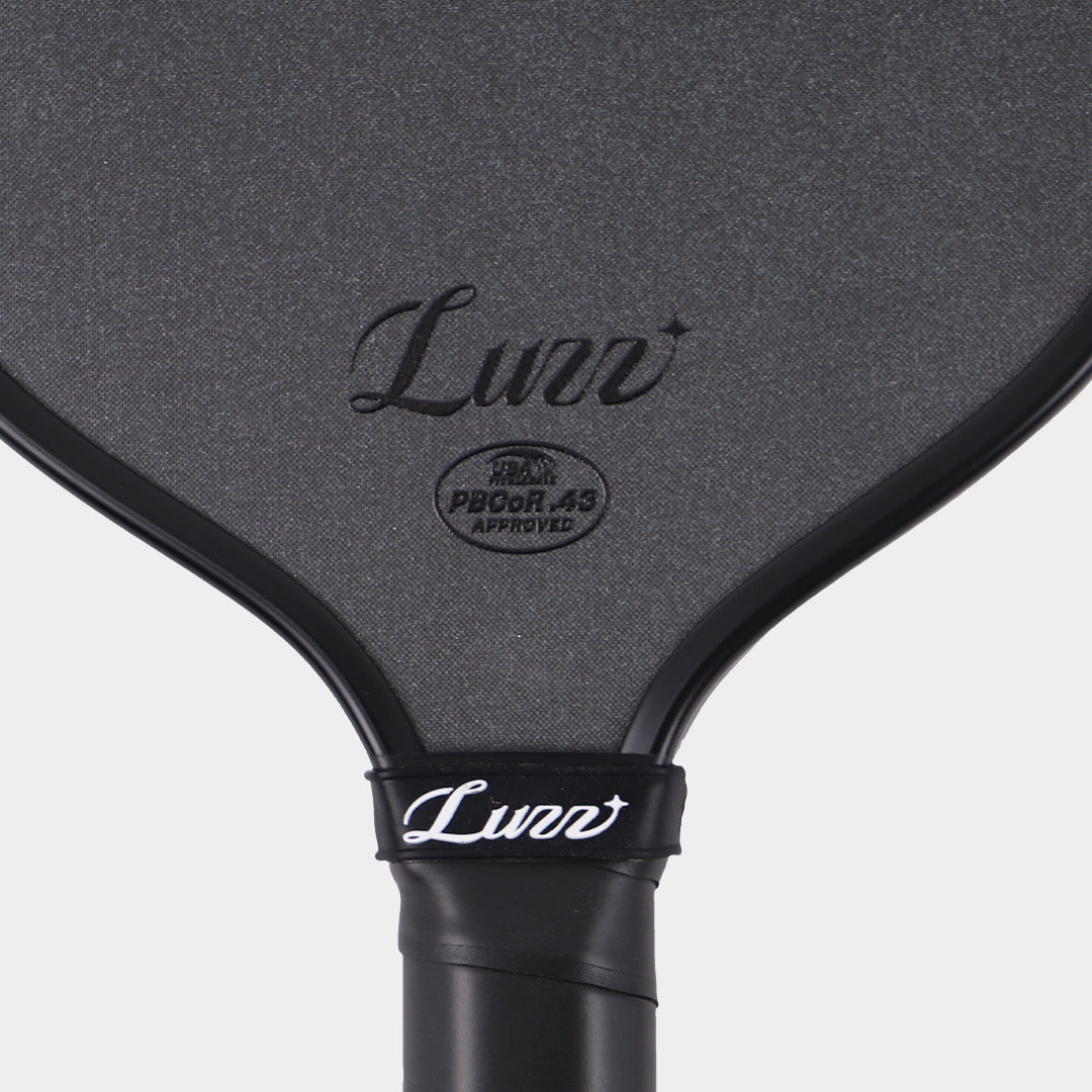 Close-up of the LUZZ Cannon XPP M1 textured face, logo and approval mark