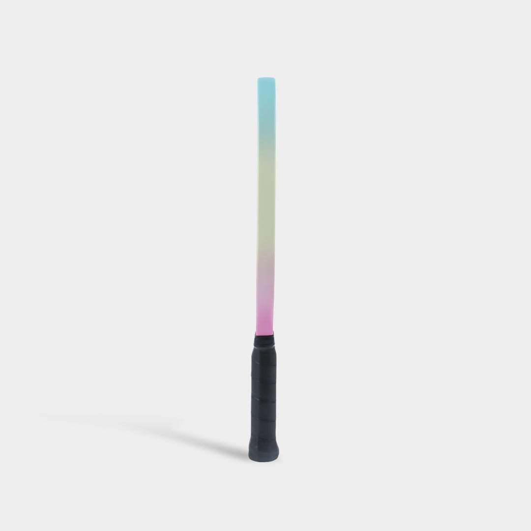 Paddle standing upright, side view, with a pastel blue-to-yellow-to-pink gradient edge.