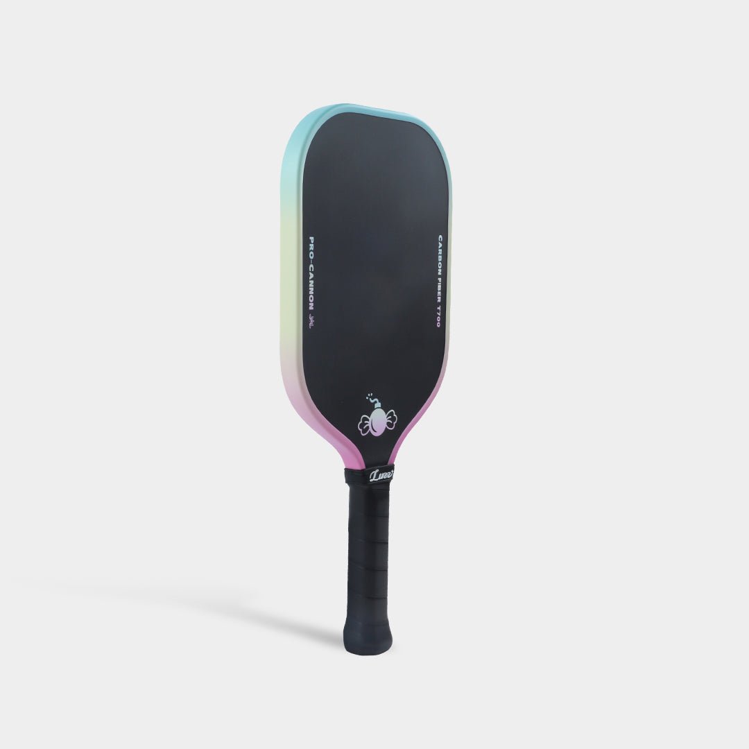 Paddle standing upright at an angled front view, with a pastel blue-to-yellow-to-pink gradient edge.