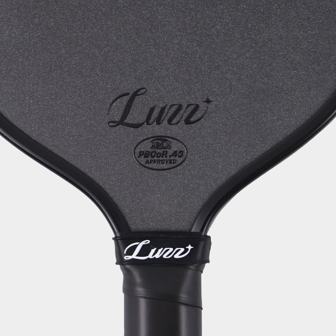 Close-up of the LUZZ Cannon XPP M1 textured face, logo and approval mark