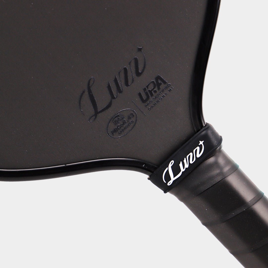 CANNON2 M1 Paddle close-up detail featuring a gloss black LUZZ logo and UPA-A and USAP certification logos at the bottom of the paddle face