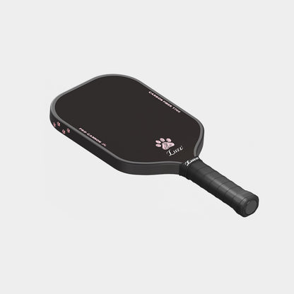 LUZZ Cat Paw Cannon pickleball paddle angled flat-lay view with the cat paw graphic facing up, black side edges, four small cat paw graphics at the top, and a black handle