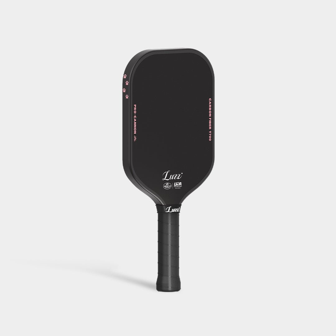 LUZZ Cat Paw Cannon pickleball paddle upright front view featuring the LUZZ logo and UPA-A and USAP certification logos, black side edges, four small cat paw graphics at the top, and a black handle