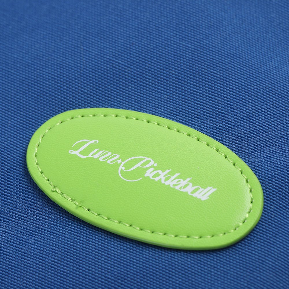 Close-up of a pickleball bag logo featuring a stitched oval leather patch with the LUZZ logo