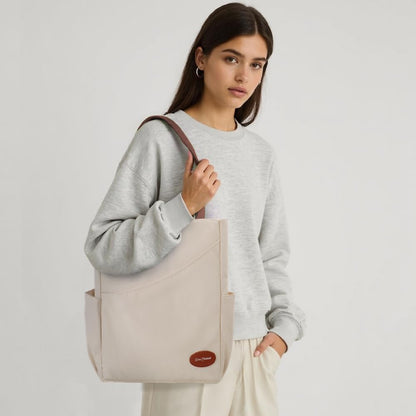 Model wearing a beige pickleball bag with brown straps
