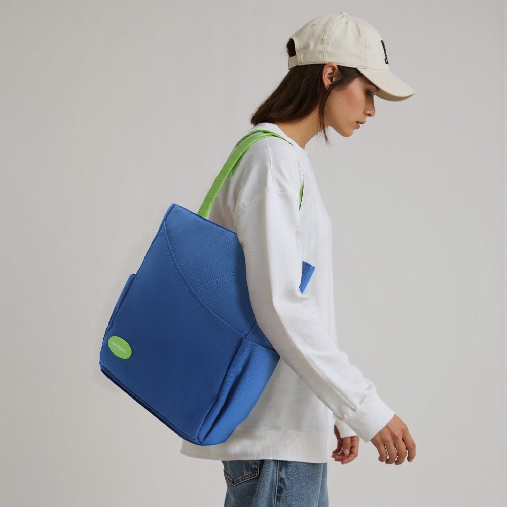 Model wearing a blue pickleball bag with green shoulder straps