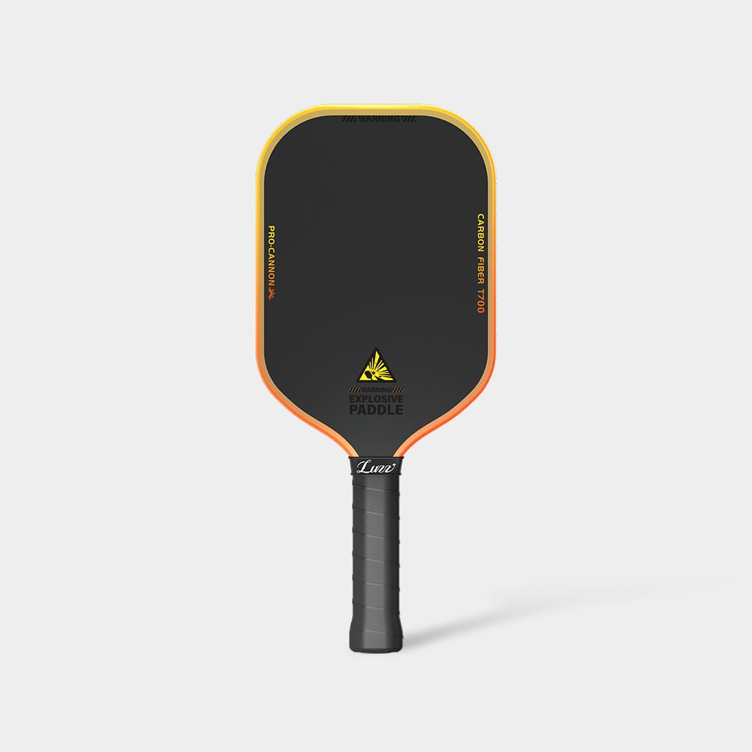 LUZZ Explosion Cannon pickleball paddle back view featuring a black paddle face with orange-to-yellow gradient “PRO-CANNON” and “CARBON FIBER T700” lettering on each side, glossy black “EXPLOSIVE PADDLE” text at the bottom, orange-to-yellow gradient edges, and a black handle