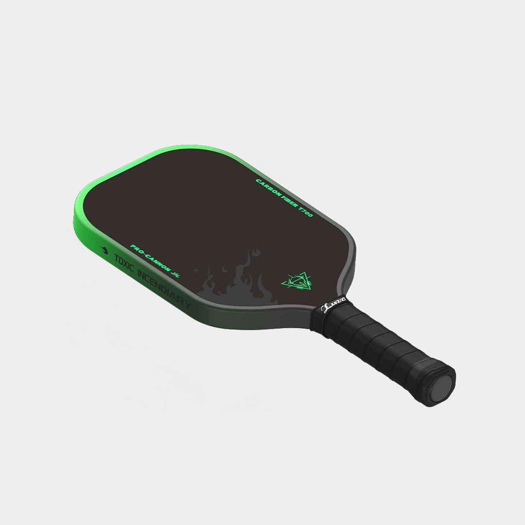 LUZZ Green Flame Cannon pickleball paddle angled flat-lay view featuring a green-to-black gradient side edge with black “TOXIC INCENDIARY” lettering and a black handle