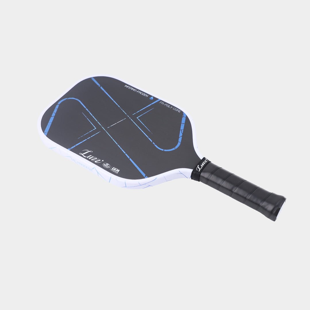 Flat-lay angled view of the paddle, featuring a white edge with light blue ice-crack patterns, white INFERNO-FROZEN and FR-POLY CORE text around the paddle face, and a black handle.