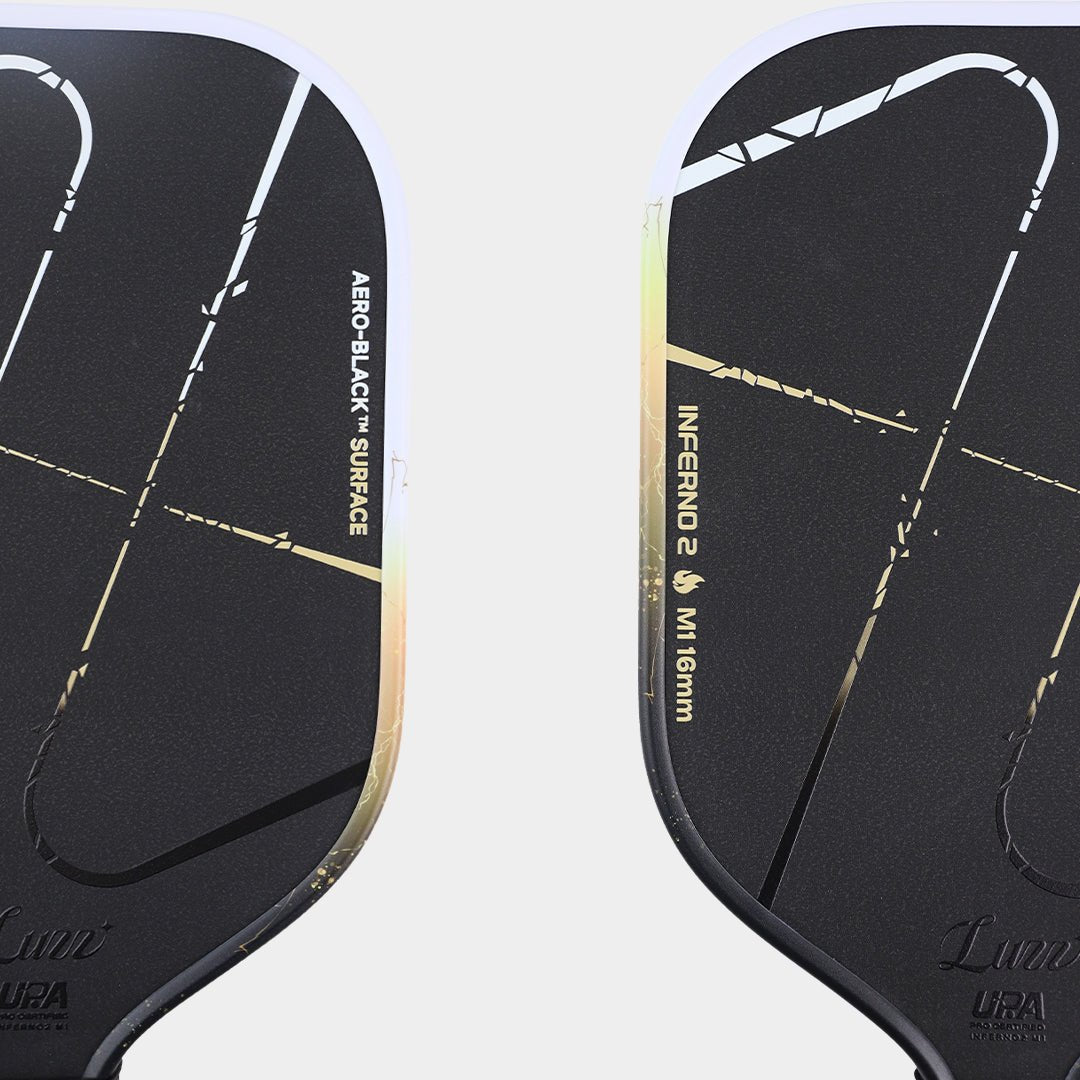 Close-up of the paddle face, featuring a matte black surface with the classic Inferno pattern and Luzz logo at the bottom.