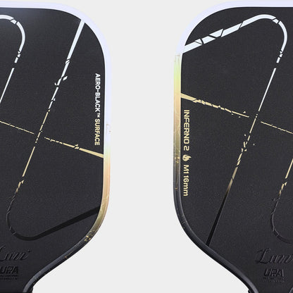 Close-up of the paddle face, featuring a matte black surface with the classic Inferno pattern and Luzz logo at the bottom.