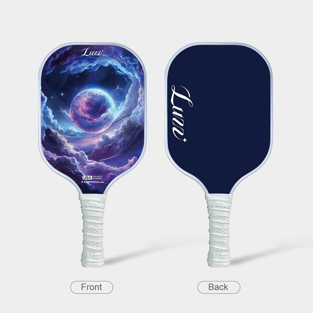 Front and back view of the paddle, featuring a dreamy planet artwork design on the front and a navy blue back with a white handle.