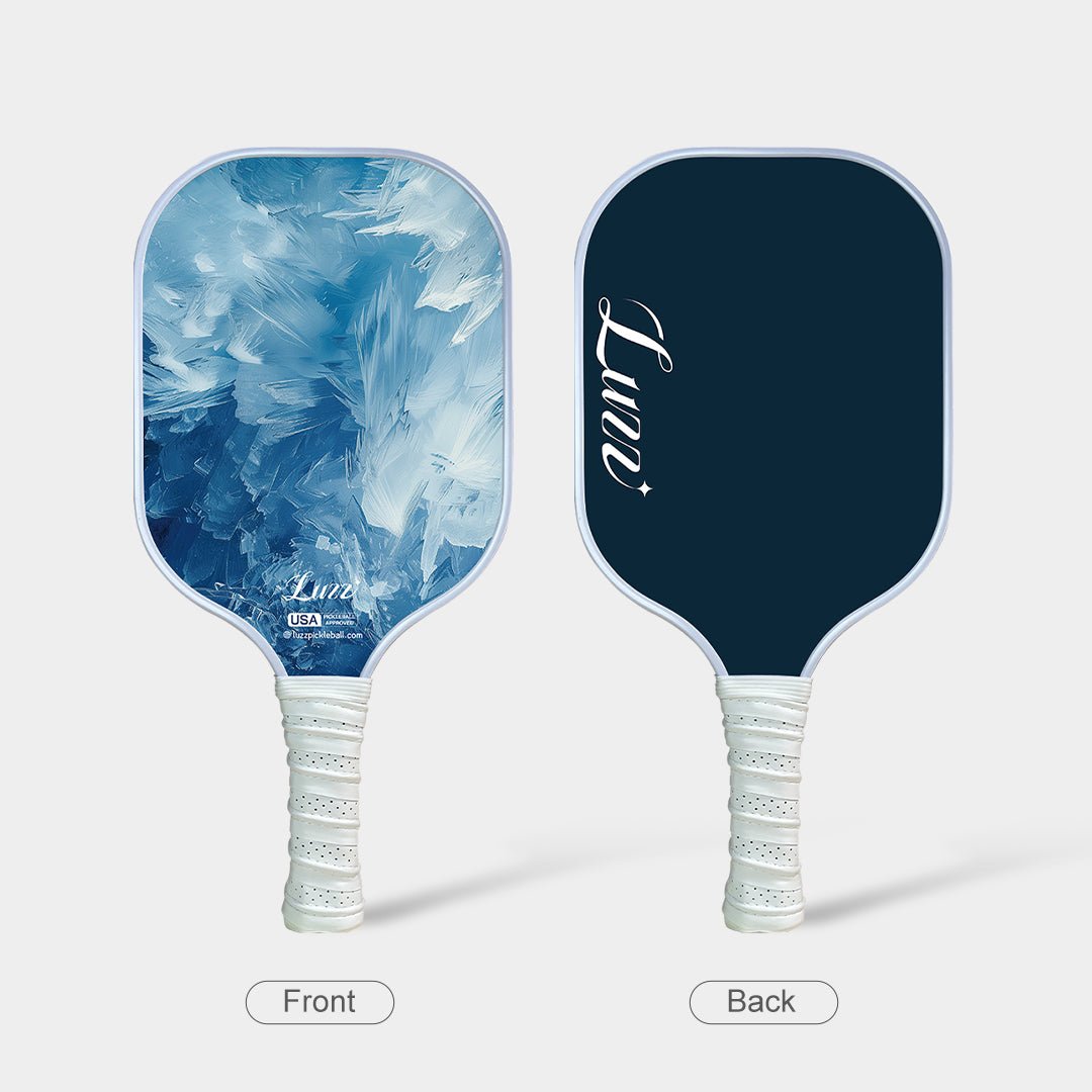 Front and back view of the paddle, featuring an oil-painting-style ice mountain landscape on the front face, a navy blue back face, and a white handle.