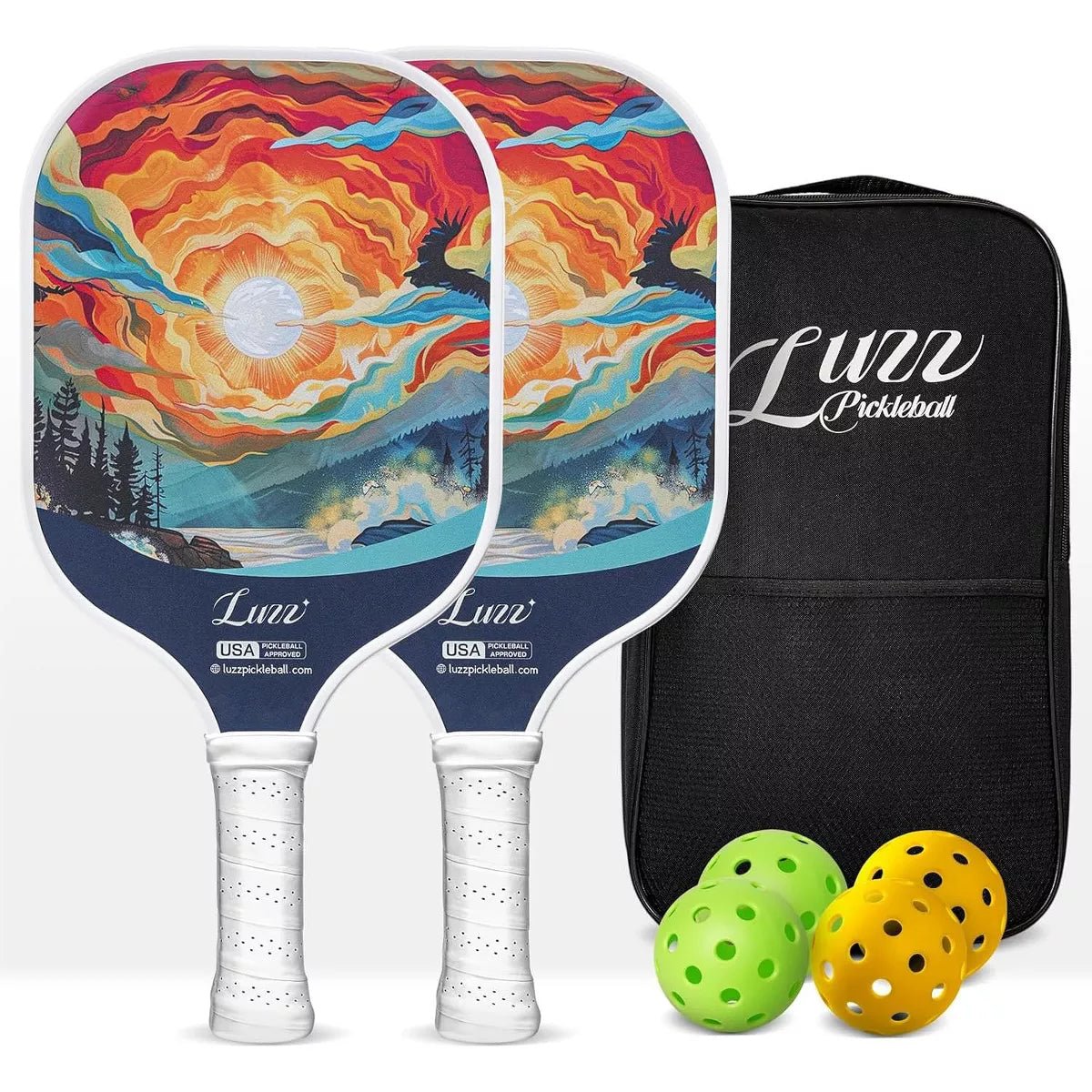 Two paddles arranged front and back, featuring an oil-painting style sunrise design on the faces and white handles. A black paddle bag, two indoor balls, and two outdoor balls are placed on the right side of the paddles.
