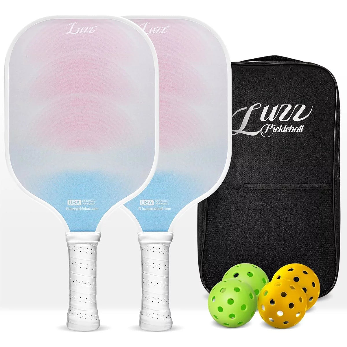 Two paddles arranged front and back, featuring pink-to-blue gradient faces with a grid pattern and white handles. A black paddle bag, two indoor balls, and two outdoor balls are placed on the right side of the paddles.