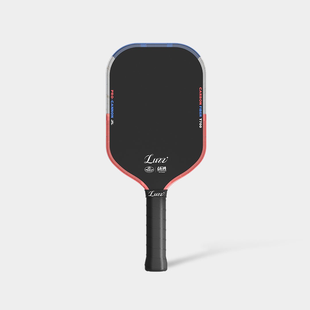 LUZZ Iron Cannon pickleball paddle featuring a solid black paddle face with blue, gray, and orange color-blocked edges, orange-and-blue “PRO-CANNON” and “CARBON FIBER T700” lettering on each side, white LUZZ logo and UPA-A and USAP certification logos at the bottom, and a black handle