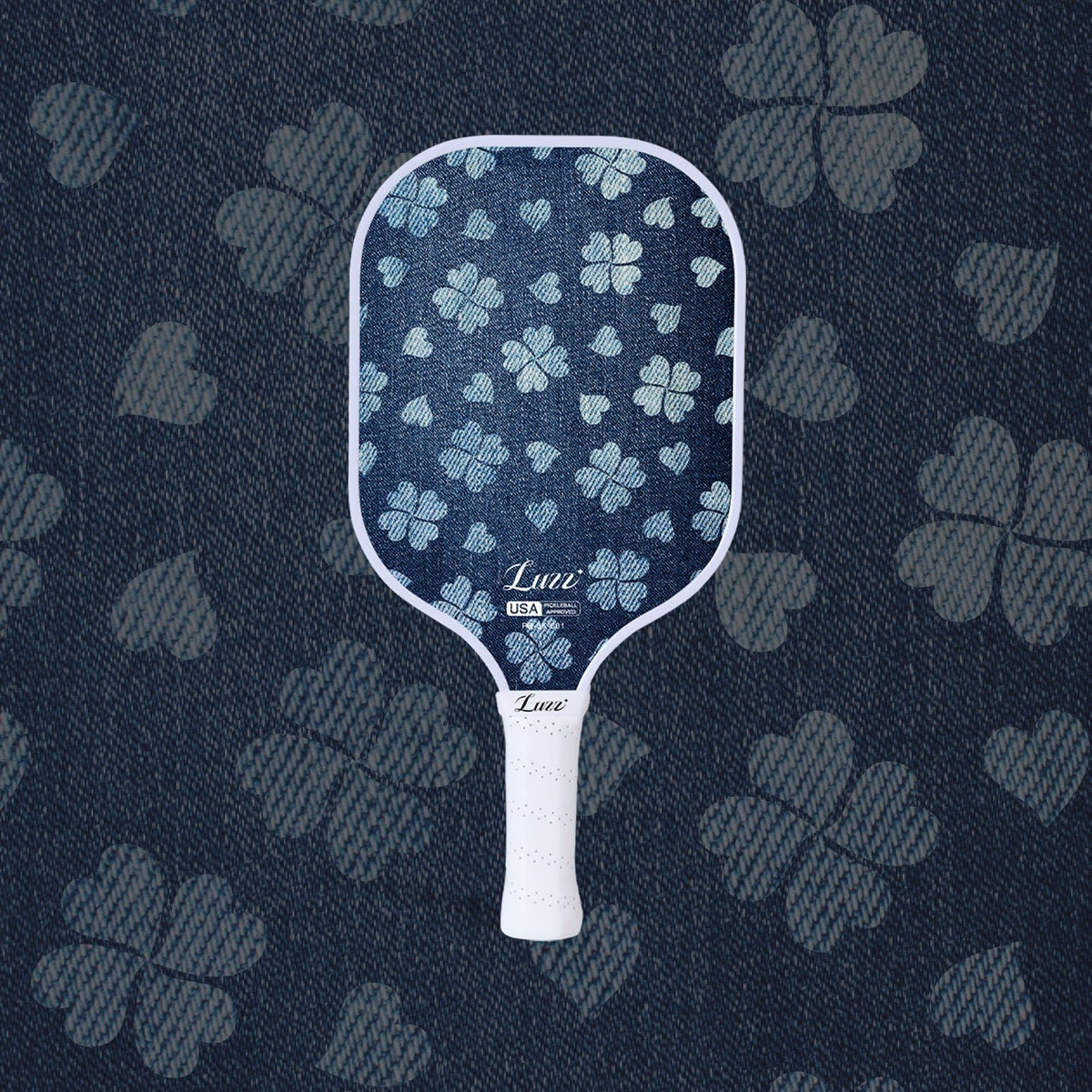 LUZZ Lucky Denim Original Paddle featuring a denim-blue paddle face with a four-leaf clover graphic, LUZZ logo at the bottom, and a white handle