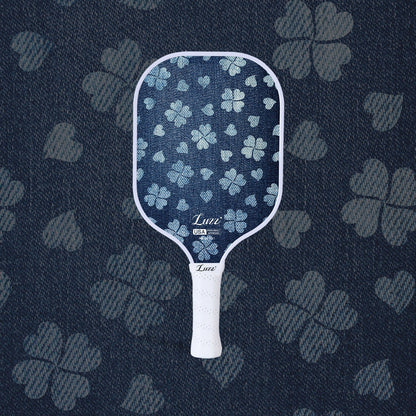 LUZZ Lucky Denim Original Paddle featuring a denim-blue paddle face with a four-leaf clover graphic, LUZZ logo at the bottom, and a white handle