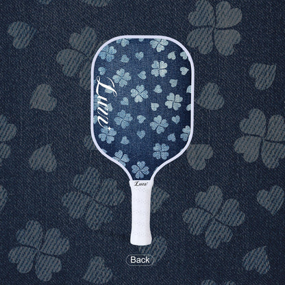 LUZZ Lucky Denim Original Paddle back view featuring a denim-blue paddle face with a four-leaf clover graphic and a script LUZZ logo on the left side