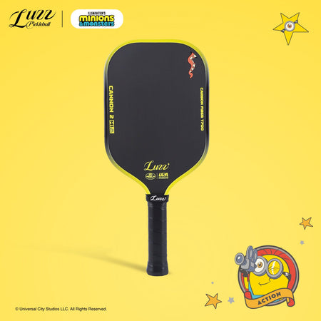 Front view of a pickleball paddle on a yellow background, featuring a yellow LUZZ logo and UPA-A and USAP certification logos