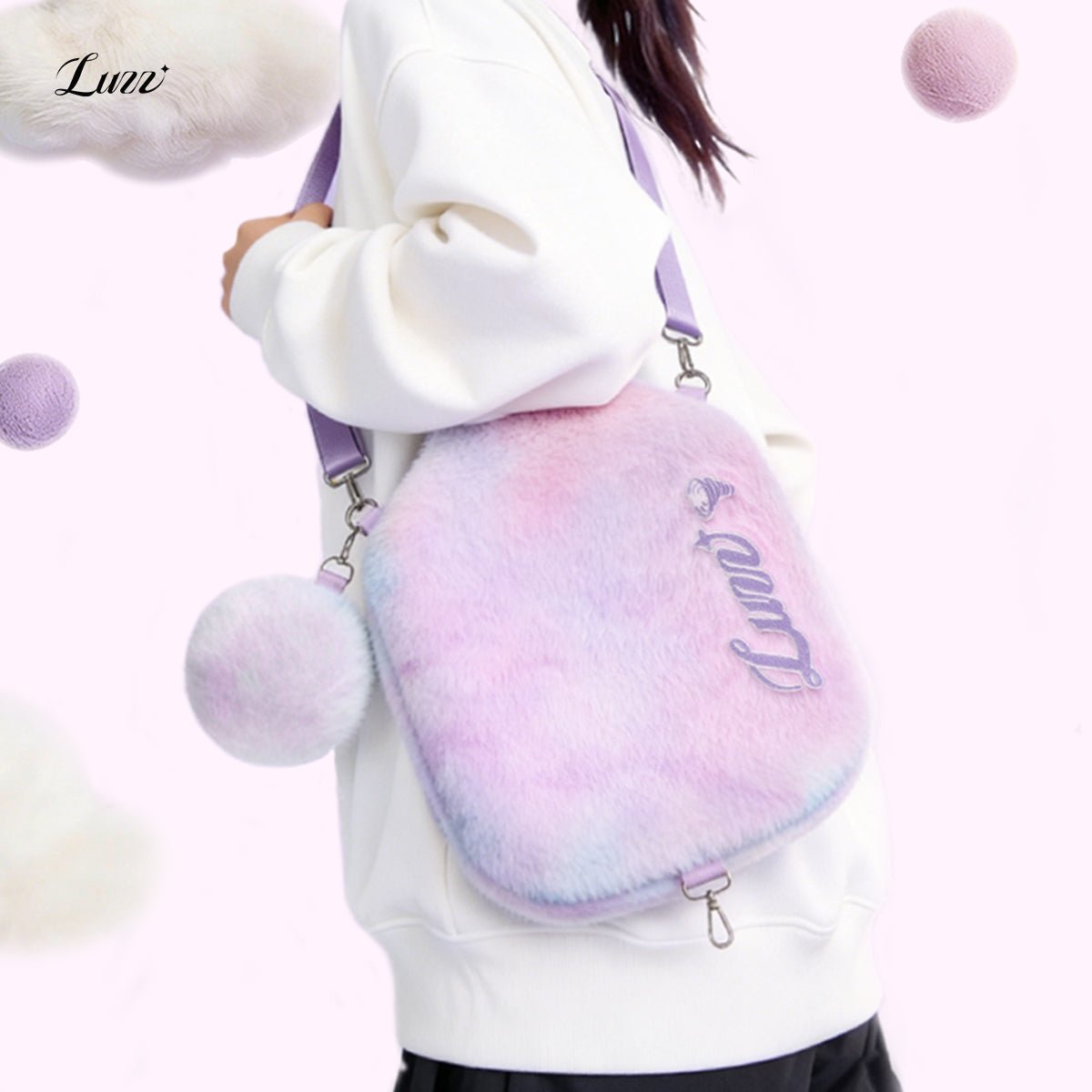 Pink-and-purple plush pickleball paddle cover worn crossbody with the front facing forward, a plush mini ball pouch attached on the left side, and the shoulder strap adjusted to a single-shoulder length