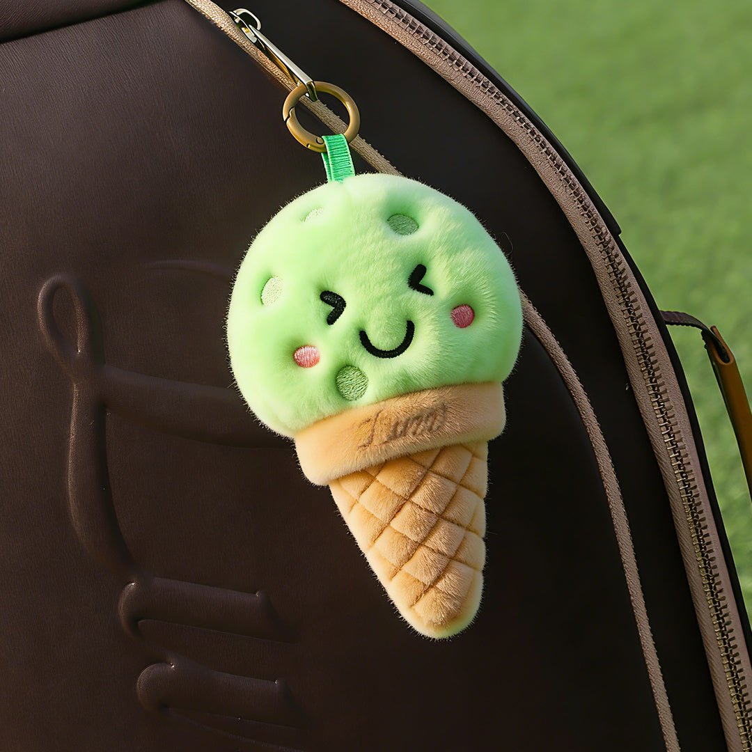 LUZZ Smiling Ice Cream Plush Charm hanging from a pickleball bag