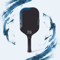 LUZZ ProBladz 2 Long Yuan pickleball paddle featuring a black paddle face with blue pattern detailing and red “ProBladz 2X” lettering at the upper left, blue gradient “CARBON FIBER T700” lettering along the right edge, white LUZZ logo and UPA-A and USAP certification logos at the bottom, and a solid black handle