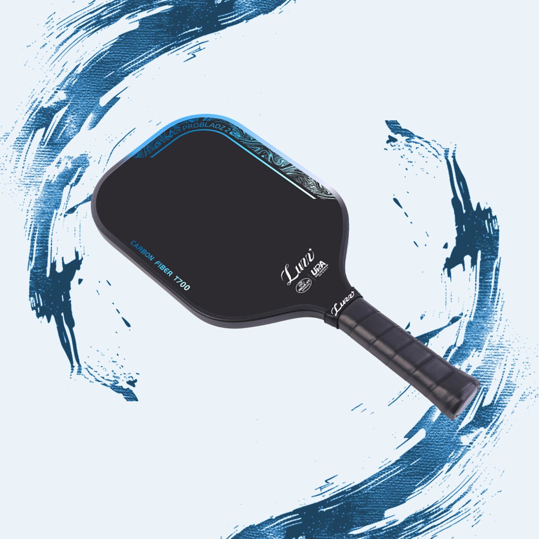 LUZZ ProBladz 2 Long Yuan pickleball paddle angled flat-lay view featuring a black side edge, blue gradient “CARBON FIBER T700” lettering along the paddle edge, and a black handle