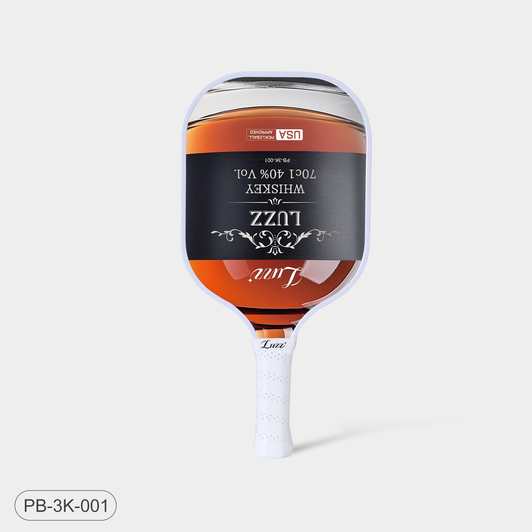 Luzz Whiskey Original Paddle standing upright, front view, featuring a liquor bottle-shaped face with a Luzz logo in the center, USAPA certification logo at the top, white edge, and white handle.