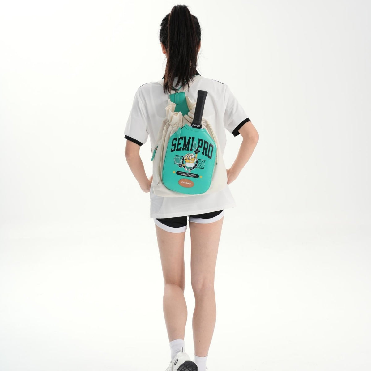 Full-body, wide-shot view of a model wearing the Vanilla Cream LUZZ Minions Collaboration Pickleball Backpack