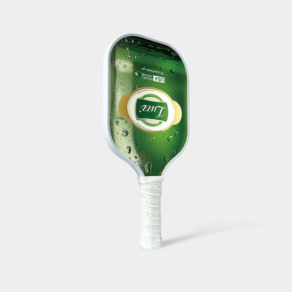 Luzz Beer Original Paddle standing upright at an angled front view, featuring a beer bottle-shaped face with a Luzz logo in the center, USAPA certification logo at the top, white edge, and white handle.